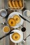 Plain Donuts with dip and cup of coffee isolated on napkin top view of baked food breakfast on table