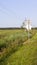 Plain with grass, electric poles and road sign at summer. background. nature.