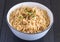 Plain noodles in small bowl close up on rustic black table