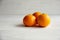 Plain orange mandarins on a grey background