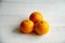 Plain orange mandarins on a grey background