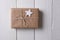 A plain paper wrapped Christmas presents with a wood star blank gift ta