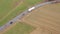 Plain white truck on a country road from above