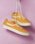 Plain yellow converse sneakers isolated on a bright background