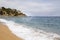 Plajan on the Costa Brava and city beach in Lloret de Mar, Spain. Sand and sea waves.