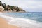 Plajan on the Costa Brava and city beach in Lloret de Mar, Spain. Sand and sea waves.