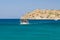 PLAKA, CRETE - 14 JULY 2021: Tourist boats heading towards the village of Plaka from the fortress island, Spinalonga