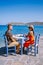 Plaka Lassithi with is traditional blue table and chairs and the beach in Crete Greece