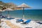 Plaka Lassithi with is traditional blue table and chairs and the beach in Crete Greece