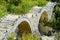 Plakidas arched stone bridge of Zagori region in Northern Greece. Iconic bridges were mostly built during the 18th and 19th