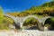 Plakidas arched stone bridge of Zagori region in Northern Greece. Iconic bridges were mostly built during the 18th and 19th