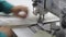 The plan operates sewing machine sews fabric, start button, modern factory, interior