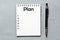 Plan text in notebook on gray background. View from above. High resolution photography - business concept.