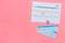 Plan a trip. Buy airplane tickets. Tickets near calendar with date circled on pink background top view copy space