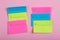 Plan of the week on colored blank stickers on pink background