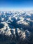 Plane above mountains with exited view through the window