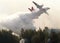 Plane drops water on a forest fire