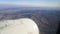 A plane flies over the brown-blue landscapes of Turkey on an October cloudless sunny day - 27s