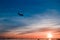 The plane flies to the airport over the river in the city of Faro in Portugal. silhouettes of airplanes and airport, boats in the