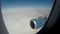 Plane flying above thick white clouds in tranquil blue sky, vacation travel