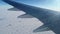 Plane flying over land covered with snow