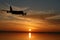 Plane flying towards sunset