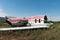 Plane fuselage wreckage sitting on the ground