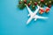 Plane, gift box, Christmas decoration on blue background. Christmas travel concept. Christmas background avia travel.