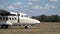 At the plane L-410 goes around the field and is preparing to fly from the window of the second pilot, a man waves his