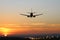 Plane lands at an airfield on the background of sunset