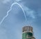 plane nose dive in sky with building, blue sky