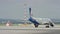 Plane parking near hangar. Big white passenger jet plane on runway at the airport on a sunny day. Airplane parked in