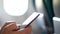 Plane passenger man texting on mobile phone on in-flight onboard wifi internet