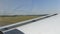 The plane picks up speed for takeoff. Small passenger plane takes off from a window on a grass field