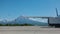 The plane is on the runway. A wing on the background of a beautiful conical volcano