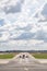 Plane taxis on runway leading to airport buildings