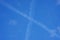 Plane traces in x shape in the sky