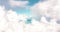 A plane traveling on beautiful white fluffy clouds under vivid and bright blue pastel sky in a suny day