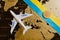 The plane and the Ukrainian flag on the background of the map with bitcoin
