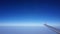 Plane wing with blue horizontal skyline with no cloud