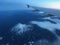 Plane Wing Flight Travel over Snowy Mountains