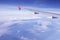 Plane wing flying over blue sky white cloud