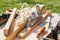 Plane, wooden blanks and tools lie on the table of the carpentry workshop on a sunny day.