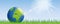 Planet earth on green meadow with sunshine banner with copy space