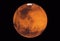 Planet Mars, with a white spot, on a dark background.  Elements of this image were furnished by NASA