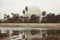 Planetarium of Castellon surrounded by palm trees under a cloudy sky in Spain