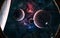 Planets of deep space against background of luminous red and blue nebulae. View from porthole of spaceship