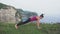 Plank exercise. Woman training on the cliff near ocean.