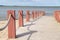 Plank footpath and fence boundary rope barrier on the beach