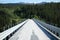 A planked bridge spanning a large river.